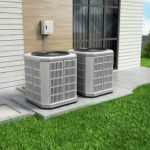 Heat pumps outside the modern house, installed near the wall.
